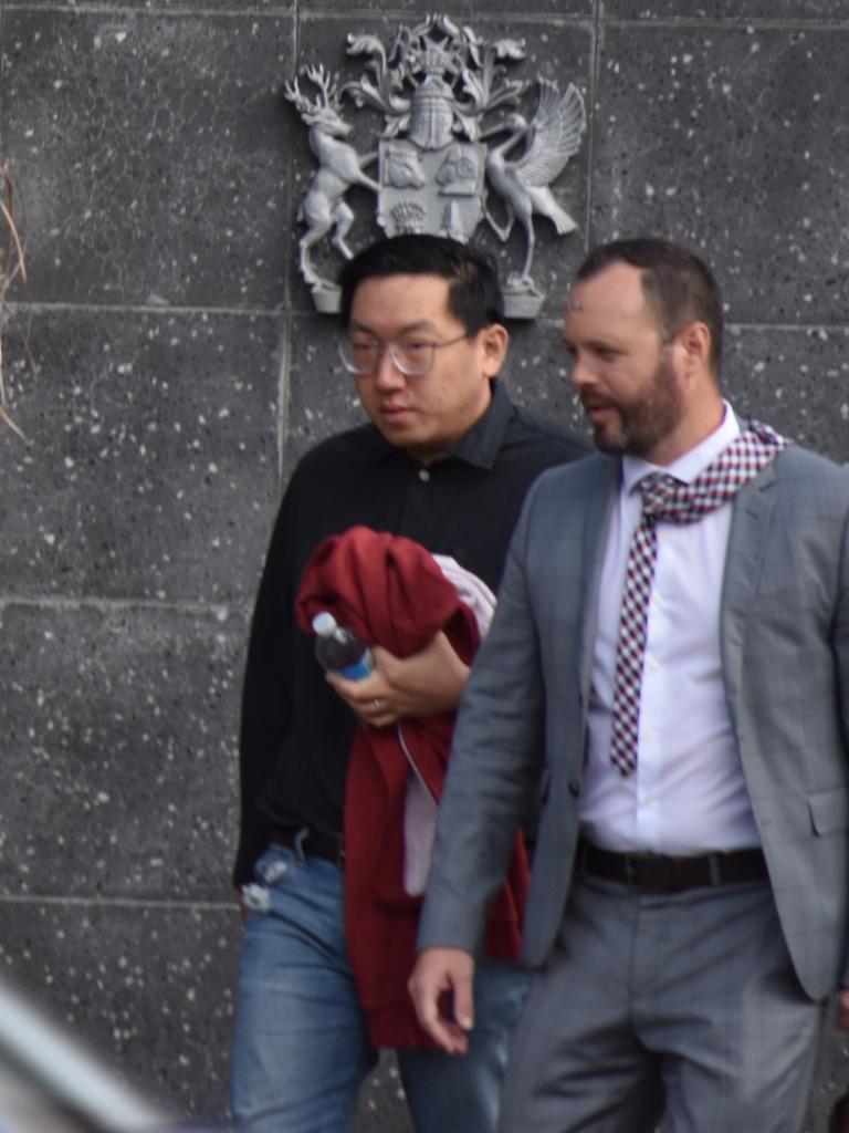 Lim Fang (left) leaving the Toowoomba Courthouse with his lawyer after pleading guilty to secretly filming women in bathrooms.
