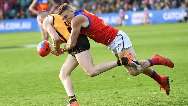 Mitch Robinson hammers Hawthorn’s Tom Scully with a crunching tackle in Brisbane’s Round 19 win in Launceston.