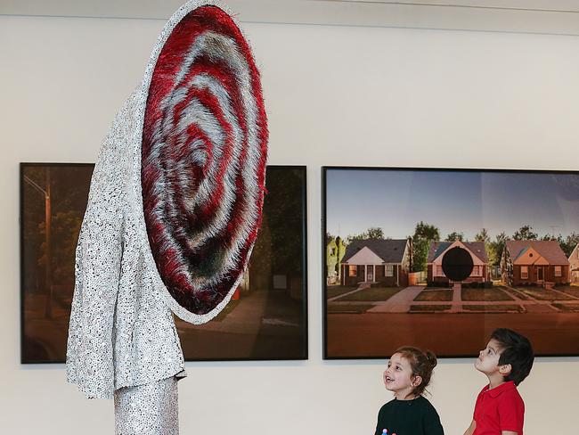 Alfie, 3, and Josh, 4, marvel at Soundsuit (2015) from Nick Cave’s Soundsuit series at the NGV. Picture: Ian Currie