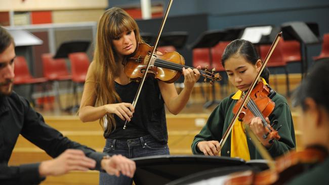 Benedetti (second left), conducts a masterclass for music students at Concord West Public School in Sydney, in 2012. Picture: Dean Lewins.