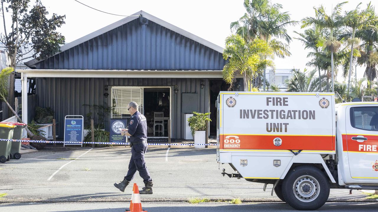 A police officer at the fire scene at Manly. Picture: Richard Walker