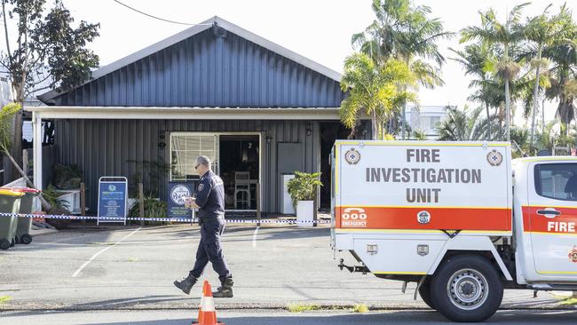 A police officer at the fire scene at Manly. Picture: Richard Walker