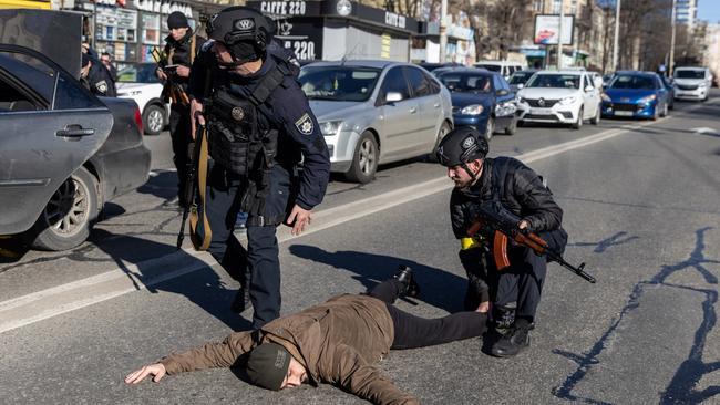 Police officers search a man at a checkpoint in Kyiv, Ukraine. Picture: Getty Images