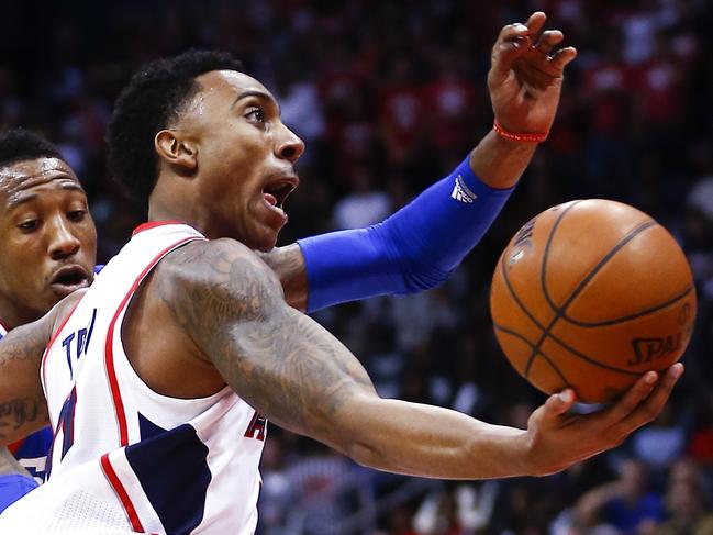 Atlanta Hawks guard Jeff Teague (0) drives against Philadelphia 76ers forward Robert Covington (33) in the first half of an NBA basketball game Saturday, Jan. 31, 2015, (AP Photo/John Bazemore)