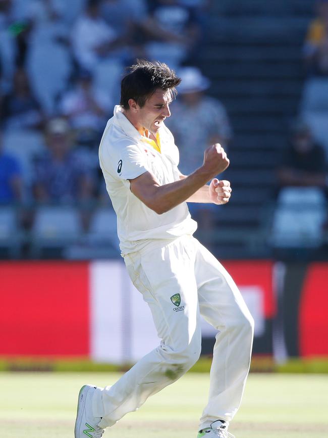 Cummins (L) celebrates a wicket during Australia’s doomed tour of South Africa. Picture: AFP