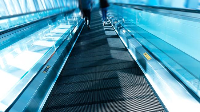 A limo driver is claiming more than $250,000 in damages after a fall on a travelator.