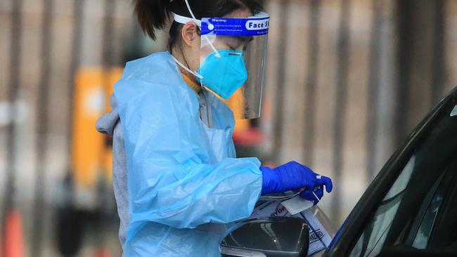 SYDNEY, AUSTRALIA - NewsWire Photos JULY 26, 2021 - Health workers testing people at the Fairfield Showground Covid testing site.Picture: NCA NewsWire / Christian Gilles