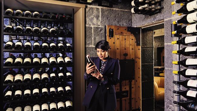 .Sommelier Liinaa Berry examining some the extensive wine collection at The Interlude.