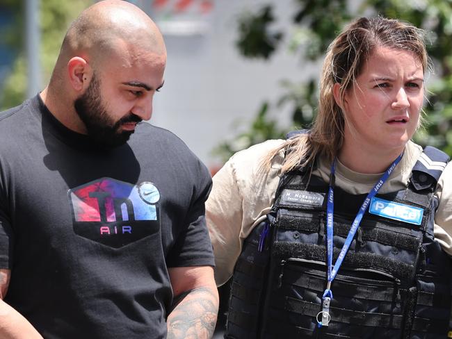 Daniel Tenace pictured. Alleged drug arrests Docklands. Two men arrested from an apartment tower in Docklands over a drugs. Police officers escort one of the men to a police car.                       Picture: David Caird