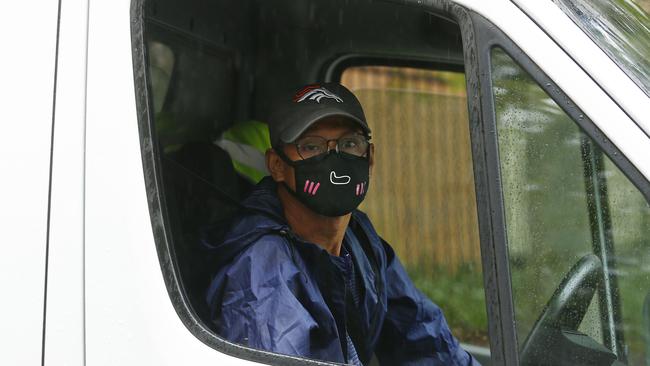 A masked courier leaves the Baptist Care Macquarie Park complex after a delivery. Picture: John Appleyard