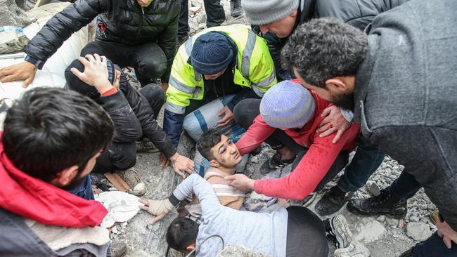 HATAY, TURKIYE - FEBRUARY 06: Mehmet Emin Ataoglu rescued under the rubble of 6-storey-building after 7.7 magnitude earthquake hits Iskenderun district of Hatay, Turkiye on February 06, 2023. Disaster and Emergency Management Authority (AFAD) of Turkiye said the 7.7 magnitude quake struck at 4.17 a.m. (0117GMT) and was centered in the Pazarcik district in TurkiyeÃƒÂ¢s southern province of Kahramanmaras. Gaziantep, Sanliurfa, Diyarbakir, Adana, Adiyaman, Malatya, Osmaniye, Hatay, and Kilis provinces are heavily affected by the quake. (Photo by Murat Sengul/Anadolu Agency via Getty Images)