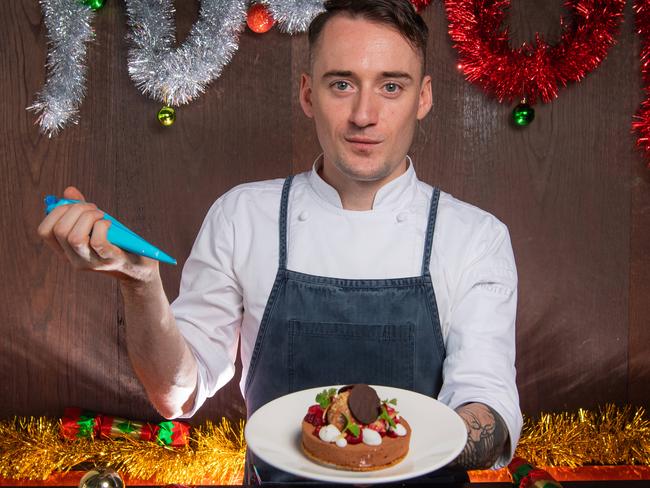 SMART DAILY COVER: Lover chef Paul Turner a Christmas dish. The story is on ways to cut food costs on Christmas Day. Christmas Wagon Wheel inspired coconut raspberry mint sable dark mouse biscuit.  Picture: Jason Edwards