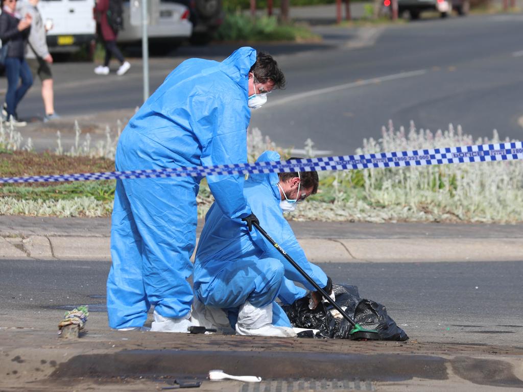 Investigators gather evidence at the scene. Picture: Brendan Beckett