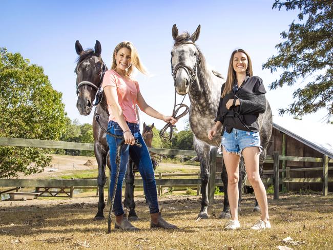 Injured jockey Tegan Harrison and Liz Cantor (pink top) with a horse, Tegan had a fall and Liz has been exercising the horses while Tegan recovers. Picture: NIGEL HALLETT