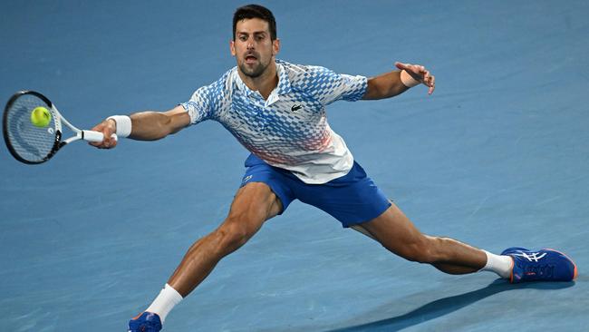 A strapping-free Novak Djokovic at full stretch for a forehand during the Australian Open men’s singles final against Stefanos Tsitsipas, which he won in straight sets. Picture: Getty Images