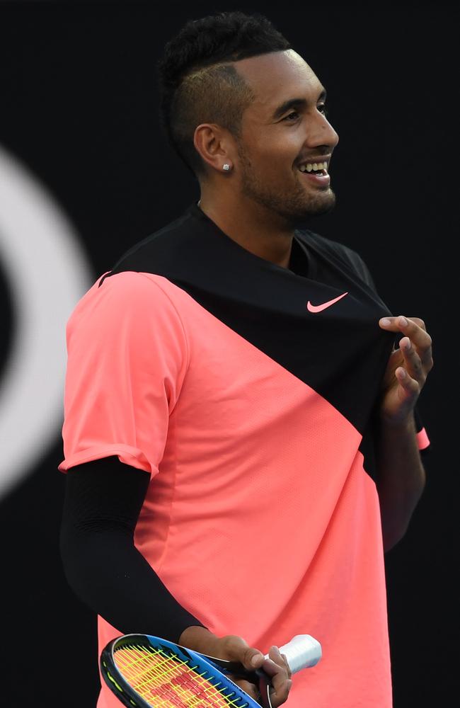 Nick Kyrgios questions the chair umpire after receiving a code violation for not being ready to start his match against Jo-Wilfried Tsonga. The Aussie had been changing his shirt. Photo: AAP