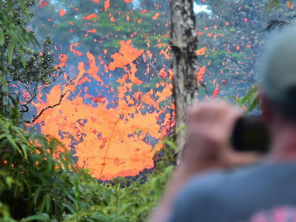 A man watches as lava is seen spewing from a fissure in the Leilani Estates subdivision near the town of Pahoa on May 4. Picture: AFP/Frederic J Brown