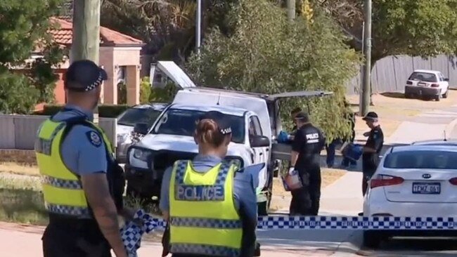 Swarms of officers crowded the suburban street.