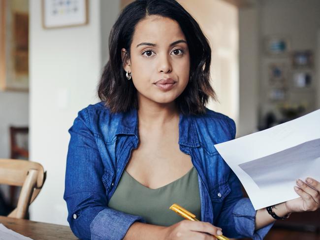 CAREERS FOR JAN 19: Shot of a young woman using a laptop and  going through paperwork while working from home.