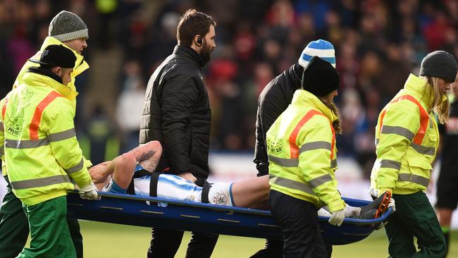 Huddersfield Town's Australian midfielder Aaron Mooy is stretchered off during the English Premier League football match between Huddersfield Town and Bournemouth.
