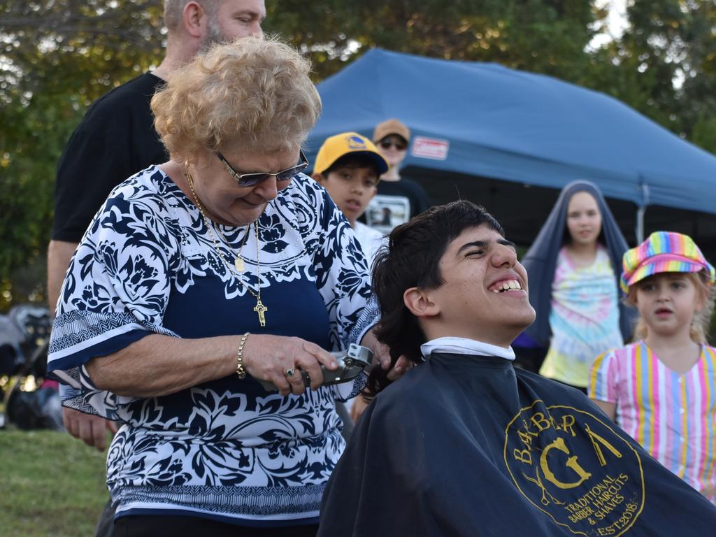 Great-grandmother Mary Vella made the first cut on her great-grandson Dean Grech's mullet at the Mackay Pioneer Valley Relay For Life, September 2021. Picture: Lillian Watkins