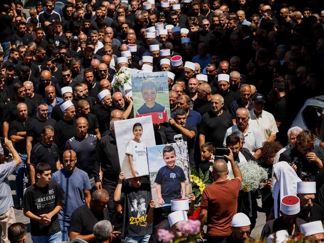 Elders and mourners carry the coffin of Guevara Ibrahim, 11, killed in a strike in the Golan. Picture: AFP