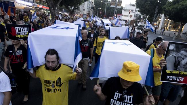 Protesters carry staged coffins covered with Israeli flags to represent 27 hostages killed in Hamas captivity in the Gaza Strip during a rally in Tel Aviv, Israel.