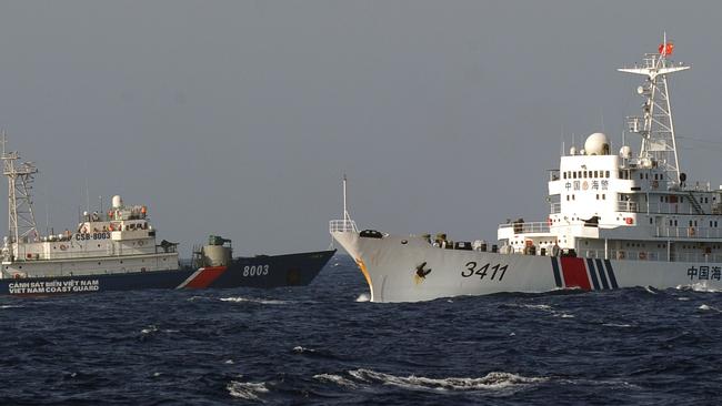Near the site of the oil rig, a Vietnamese Coast Guard ship (blue) goes past a Chinese Coast Guard ship (white). Pic: AFP
