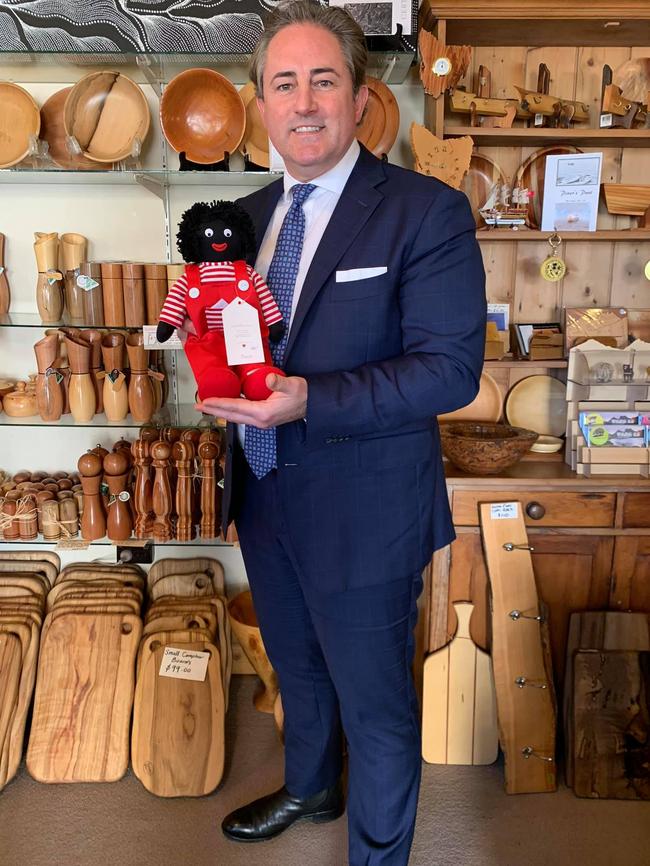 Clarence Alderman Brendan Blomeley with a golliwog at The Woodcraft Shop in Richmond. Picture: FACEBOOK