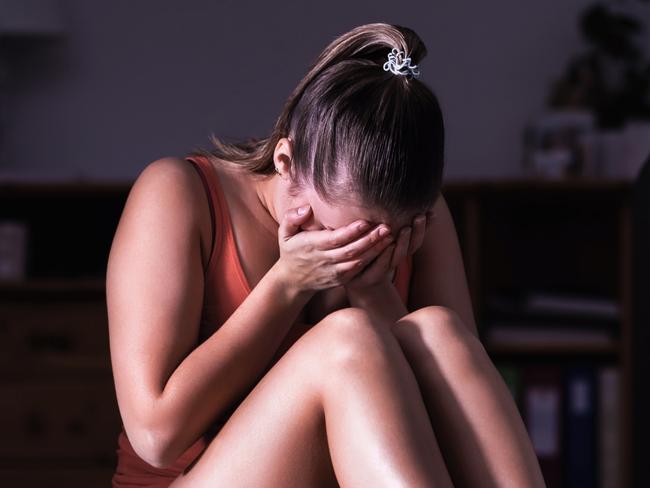 Victim of sexual harassment, domestic violence or abuse. Young sad woman crying and sitting on the floor at home. Ashamed, scared or lonely lady suffering emotional pain. Stress, trauma or sorrow. istock image