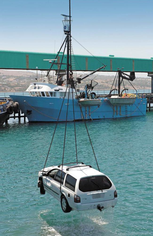 The Ford Falcon is lifted from the water at Port Lincoln. Picture: Ivon Perrin