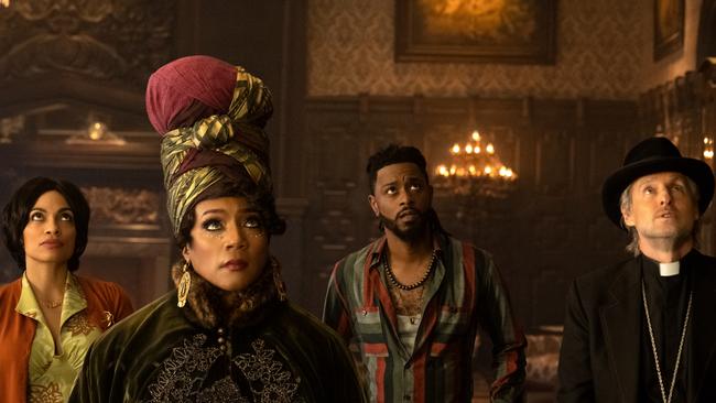 Rosario Dawson as Gabbie, Tiffany Haddish as Harriet, LaKeith Stanfield as Ben, and Owen Wilson as Father Kent in the theme park ride adaptation Haunted Mansion.