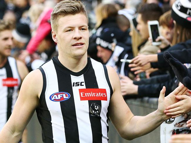 MELBOURNE, AUSTRALIA - JULY 21:  Jordan de Goey of the Magpies celebrates the win with fans during the round 18 AFL match between the Collingwood Magpies and the North Melbourne Kangaroos at Melbourne Cricket Ground on July 21, 2018 in Melbourne, Australia.  (Photo by Michael Dodge/Getty Images)