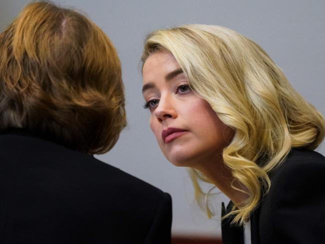 Actor Amber Heard talks with her lawyer Elaine Bredehoft at the Fairfax County Circuit Courthouse in Fairfax, Virginia on May 18, 2022. Picture: AFP