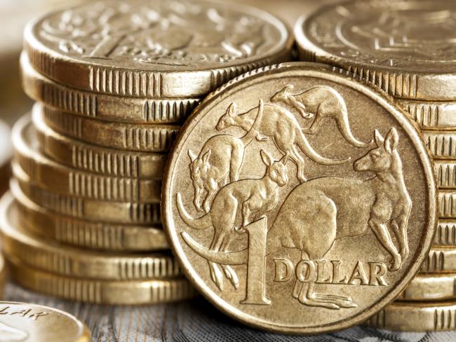 Stacks of Australian one dollar coins. Focus on front coin.