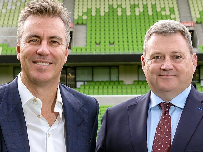 NRL. Melbourne Storm exiting chairman Bart Campbell hands the reigns over to new chairman Matt Tripp, with Captain Cameron Smith and coach Craig Bellamy looking on at AAMI Park , Melbourne. Had to shoot waist up as Cameron Smith had incorrect pants on. Picture : Ian Currie