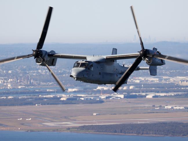 An MV-22 Osprey flying over Brisbane on Tuesday morning, before landing on the USS America just off shore. Picture: Liam Kidston