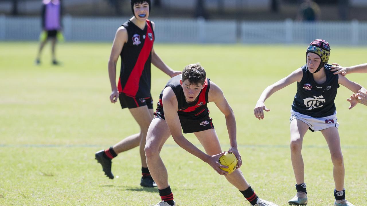 Jack Barwick gets possession for South Toowoomba Bombers under pressure from Eli Silver of Coolaroo in U14 AFL Darling Downs grand final at Rockville Park, Saturday, September 2, 2023. Picture: Kevin Farmer