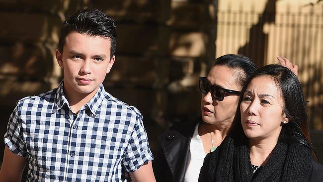 Keanu Dallas, left, with his mother Veny Amelia, right, and a supporter, centre, outside the Supreme Court. Picture: Roger Wyman.