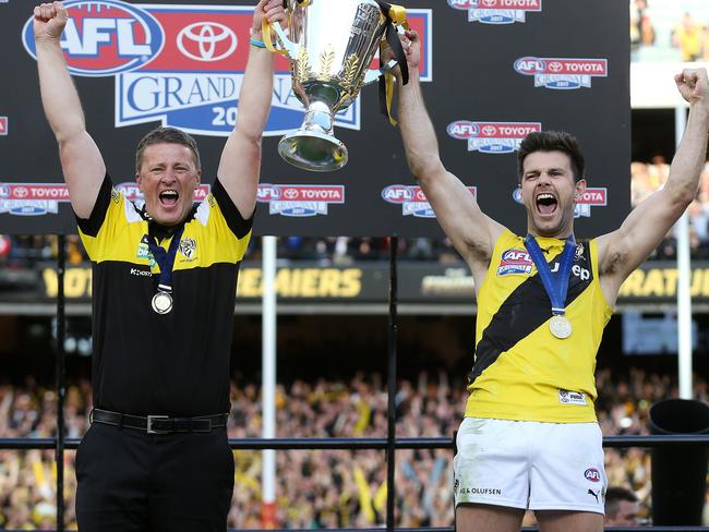 Tigers coach Damien Hardwick and captain Trent Cotchin hold the cup aloft . Pic: Michael Klein