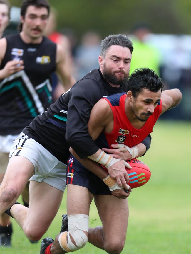 Swifts Creek’s Arthur Wright is tackled by Omeo-Benambra’s Ross Ansaldi.