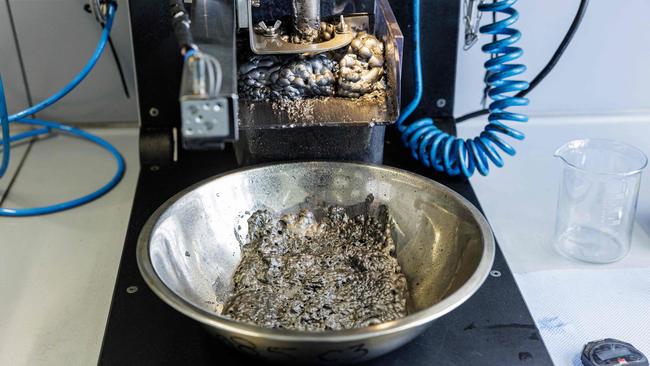 Researcher Anna Vanderbruggen peers into a vat of dark bubbling liquid, the result of a process she has developed to recover graphite from old lithium-ion batteries. Picture: AFP