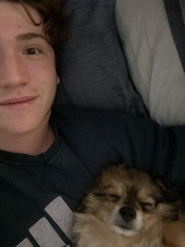 Jason Strum, 14, in bed with dog Rocco after being diagnosed with Covid. Picture: Supplied