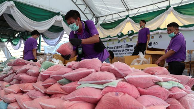 Thai narcotics officials arrange bags of methamphetamine pills seized in Thailand. Picture: Retuers