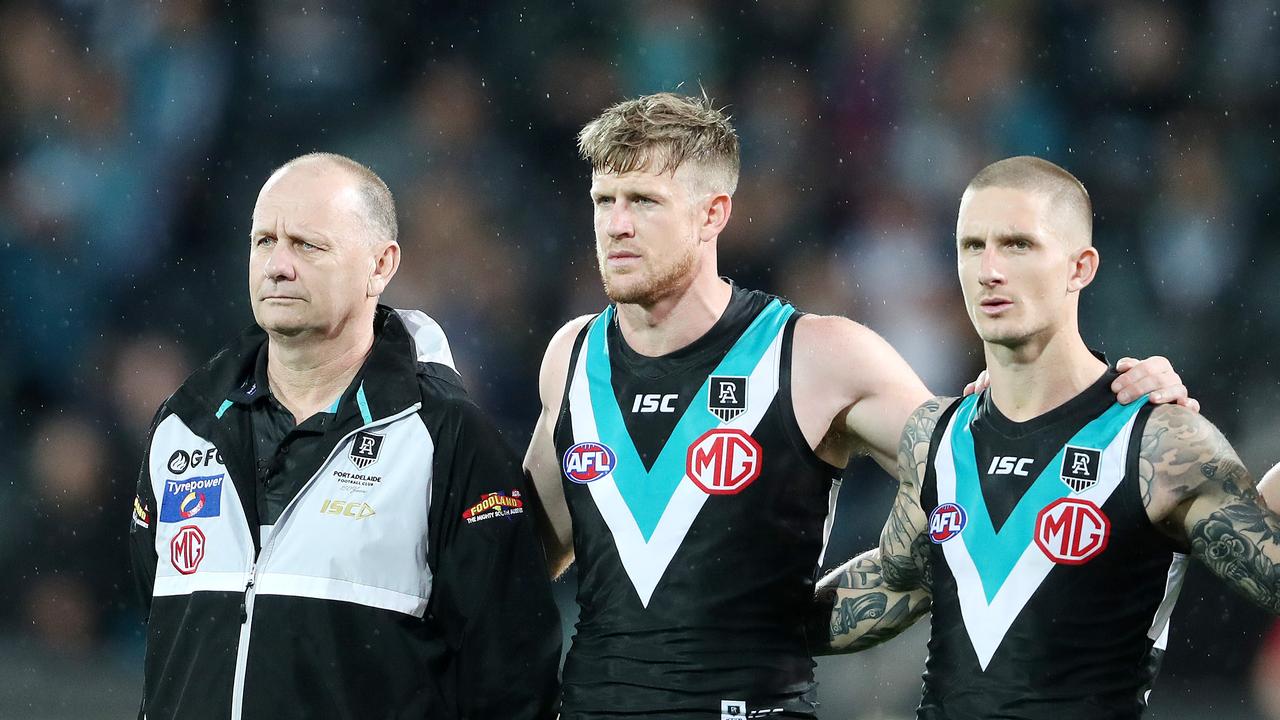 Port Adelaide coach Ken Hinkley stands with his captain Tom Jonas and deputy Hamish Hartlett during the national anthem Picture: Sarah Reed