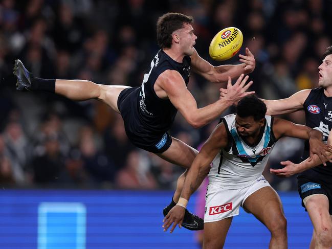 Lachlan Cowan of the Blues flies over Willie Rioli of the Power. Picture: Mark Stewart