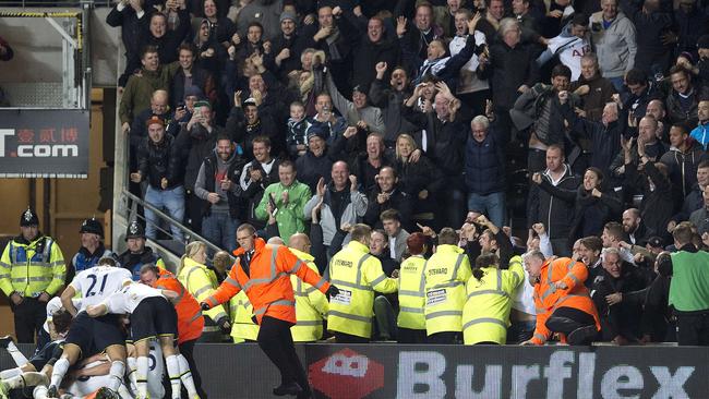 Tottenham Hotspur players and fans celebrate the winner.