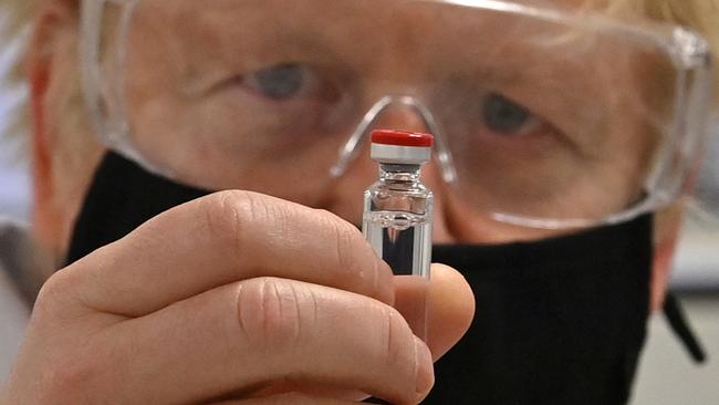 British Prime Minister Boris Johnson with a vial of the AstraZeneca/Oxford University COVID-19 candidate vaccine, known as AZD1222, in Wrexham, Wales, last Monday. Picture: Pool/Getty Images