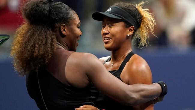 Williams comforts Naomi Osaka at the net after their match. Picture: AFP