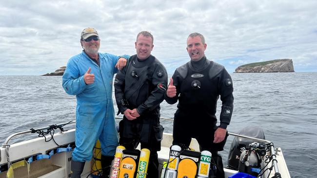 Michael Baron (Eaglehawk Dive Centre), Brad Turner (Scuba Diving Tasmania), and James Parkinson after a successful dive on the SS Tasman.